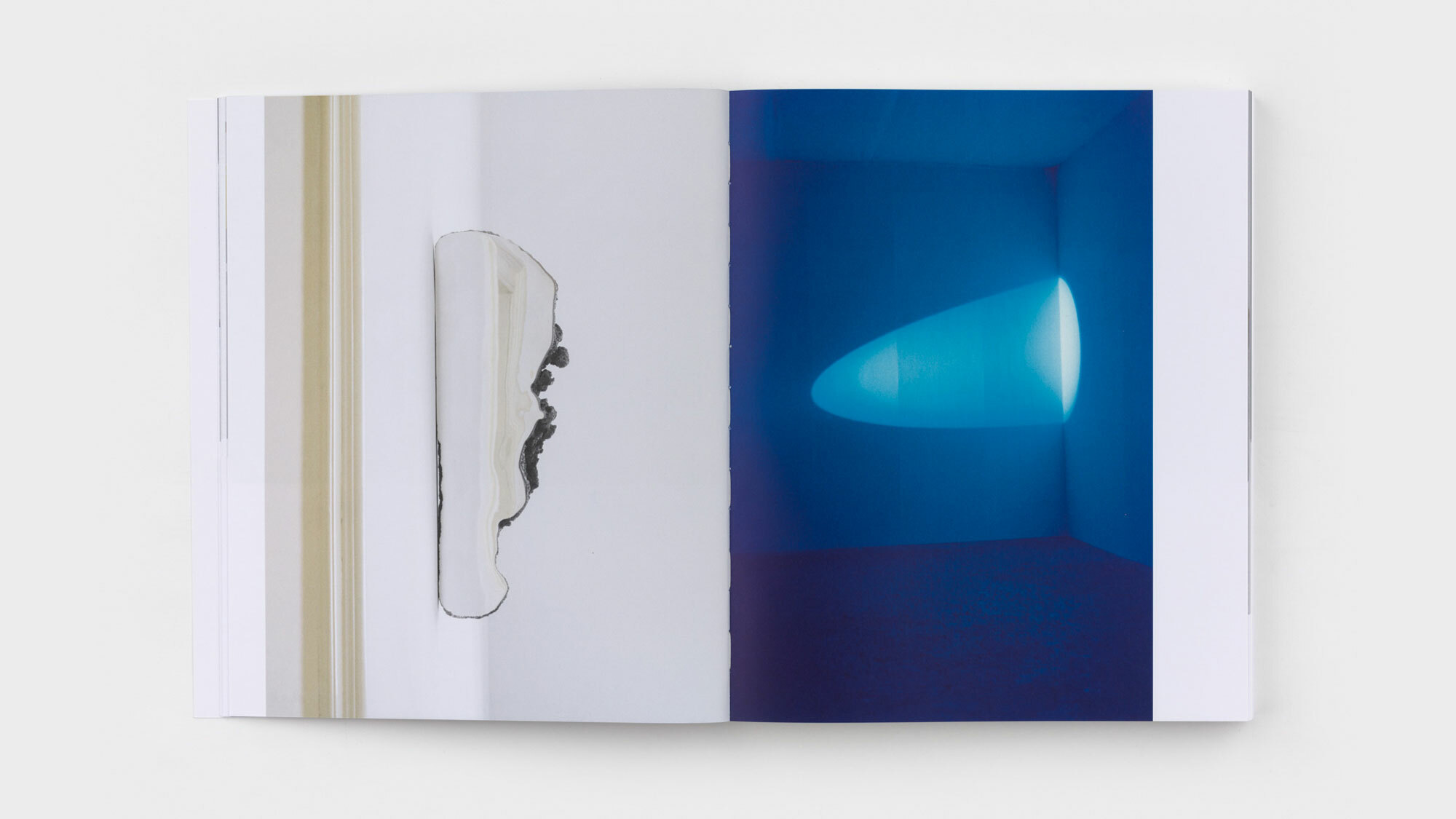 Here again, a juxtaposition. François has adjoined a mirror to one side of a geode. Janssens casts an ovular white light into the corner of a room drenched in blue. 